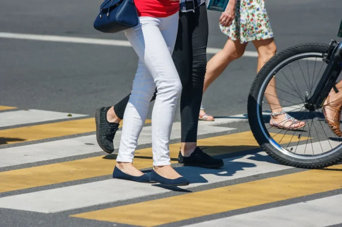 Pedestrians crossing a street at a crosswalk, emphasizing personal injury claims and safety in urban environments.